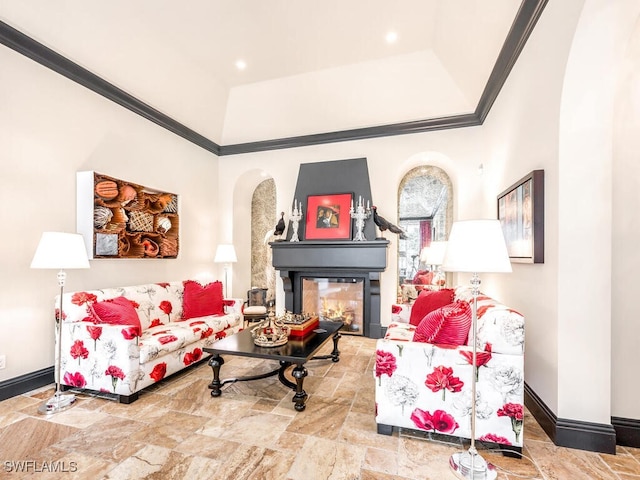 living room featuring ornamental molding and a multi sided fireplace