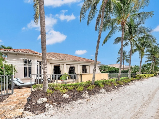 18281 Via Caprini Dr, Miromar Lakes, FL 33913 - mediterranean / spanish house featuring a tiled roof and stucco siding