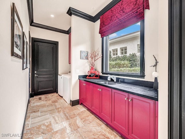 bathroom featuring crown molding, vanity, and independent washer and dryer