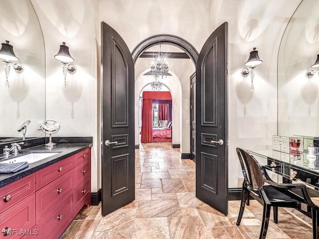 bathroom featuring vanity and a chandelier