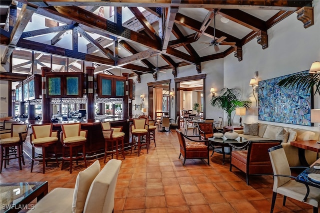 18281 Via Caprini Dr, Miromar Lakes, FL 33913 - living area with a ceiling fan, high vaulted ceiling, beamed ceiling, and light tile patterned floors