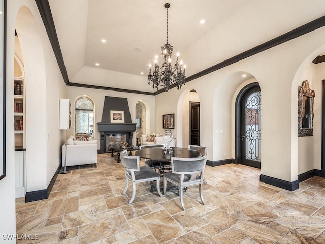 dining space featuring crown molding, a tray ceiling, and an inviting chandelier