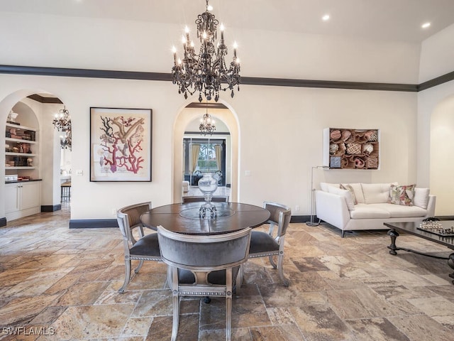 dining area featuring built in features and a notable chandelier