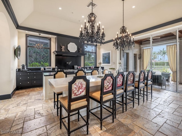 dining area featuring crown molding and a notable chandelier