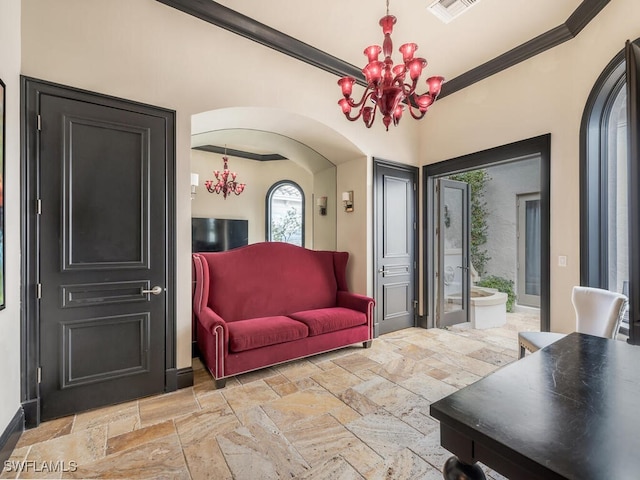 living area featuring a notable chandelier and ornamental molding