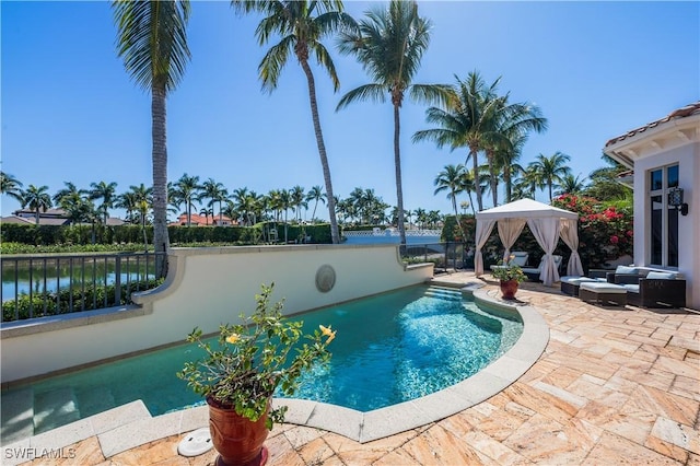 view of swimming pool with a gazebo, a patio area, and fence