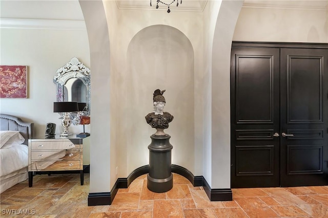 18281 Via Caprini Dr, Miromar Lakes, FL 33913 - hallway with stone tile floors, arched walkways, and ornamental molding