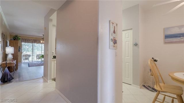 hallway with baseboards and light tile patterned floors