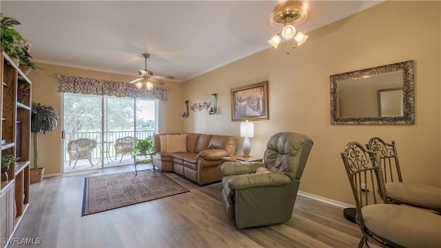 living room featuring baseboards, ornamental molding, ceiling fan, and wood finished floors