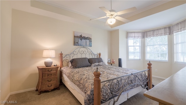 carpeted bedroom with crown molding, multiple windows, and ceiling fan