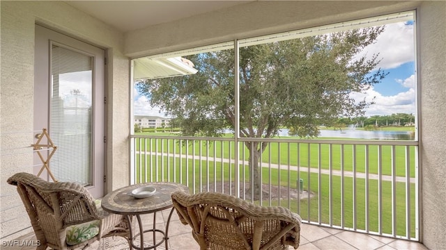 sunroom / solarium featuring a water view