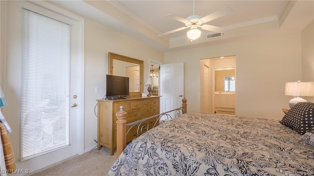 carpeted bedroom with ornamental molding, a tray ceiling, ceiling fan, and visible vents