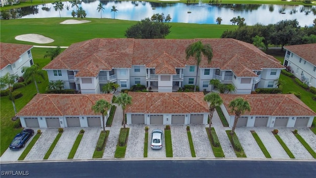drone / aerial view featuring view of golf course and a water view