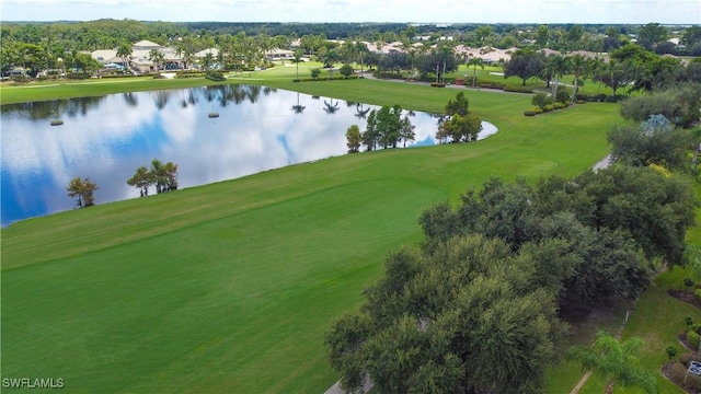 drone / aerial view with a water view and view of golf course