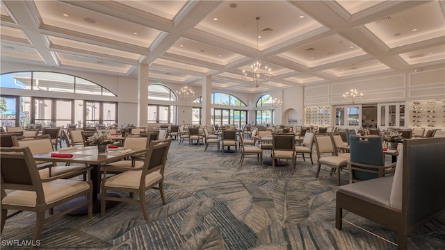 dining area with coffered ceiling, a chandelier, beamed ceiling, a towering ceiling, and carpet