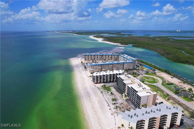 birds eye view of property featuring a beach view and a water view