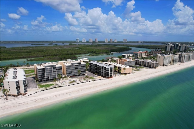 aerial view with a water view and a beach view