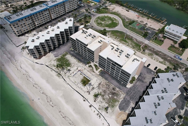 drone / aerial view featuring a beach view and a water view