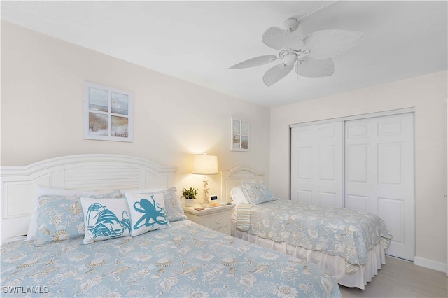 bedroom with ceiling fan and a closet