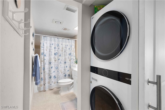 washroom featuring stacked washer and dryer