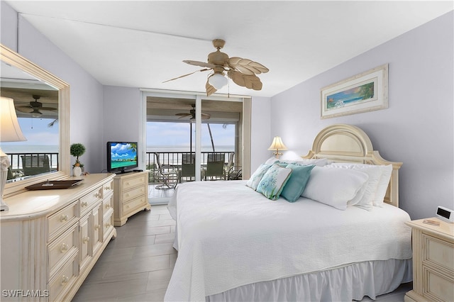 bedroom featuring multiple windows, ceiling fan, and access to exterior