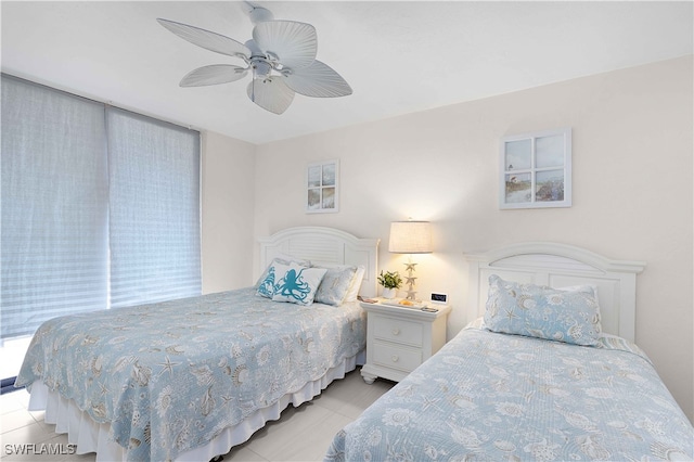 tiled bedroom featuring ceiling fan