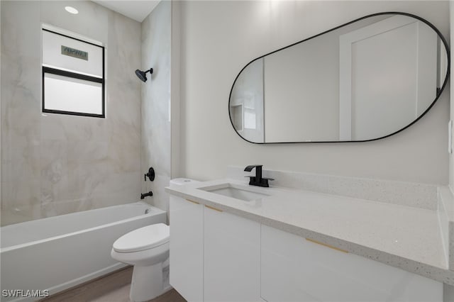 full bathroom featuring wood-type flooring, toilet, tiled shower / bath combo, and vanity