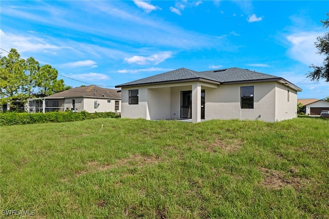 rear view of house with a lawn