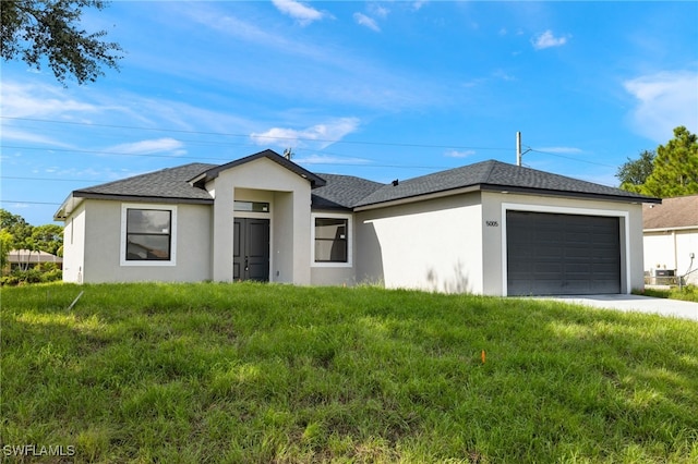 single story home with a front yard and a garage