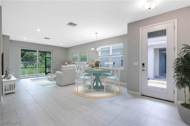 tiled living room featuring a notable chandelier