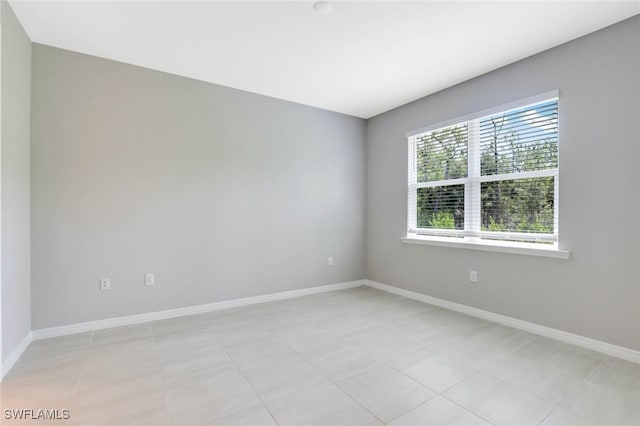 spare room featuring light tile patterned flooring