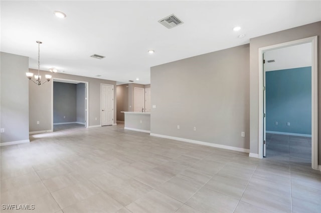 unfurnished living room with a chandelier