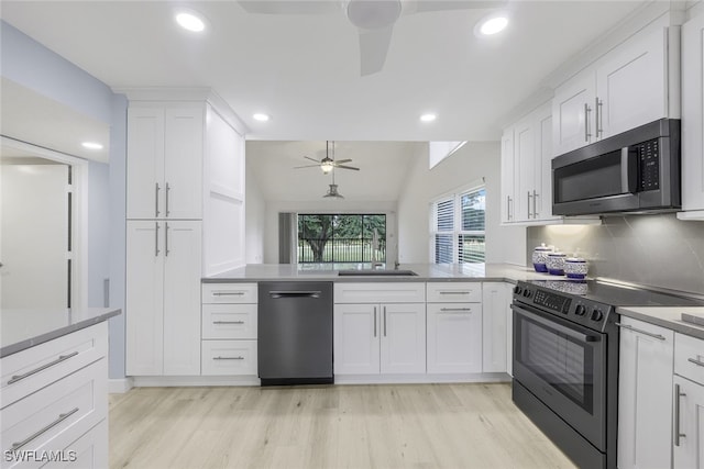 kitchen with dishwashing machine, backsplash, white cabinets, electric range oven, and lofted ceiling