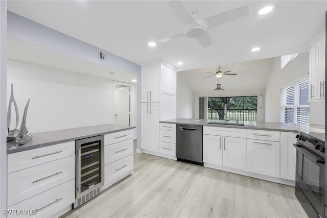 kitchen featuring wine cooler, white cabinetry, oven, dishwasher, and a peninsula