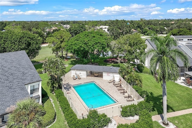 community pool with a patio area and a fenced backyard