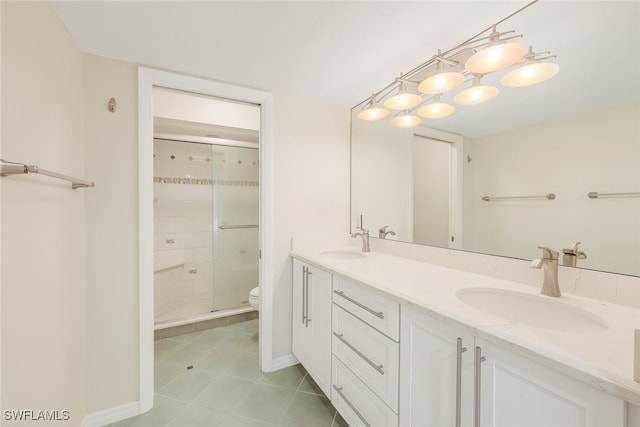 bathroom with a stall shower, a sink, and toilet