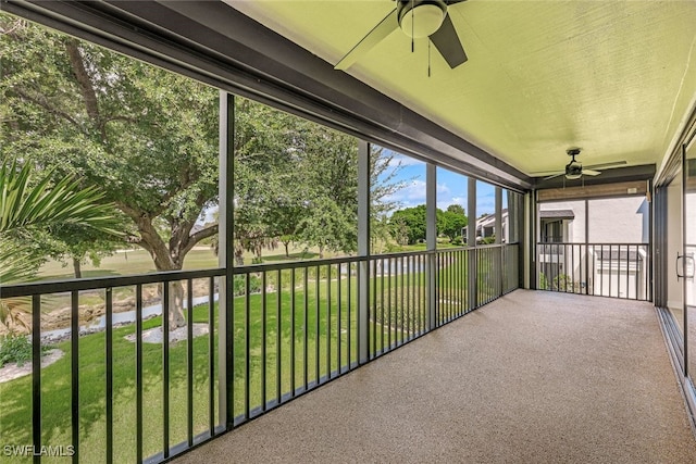 unfurnished sunroom with a ceiling fan