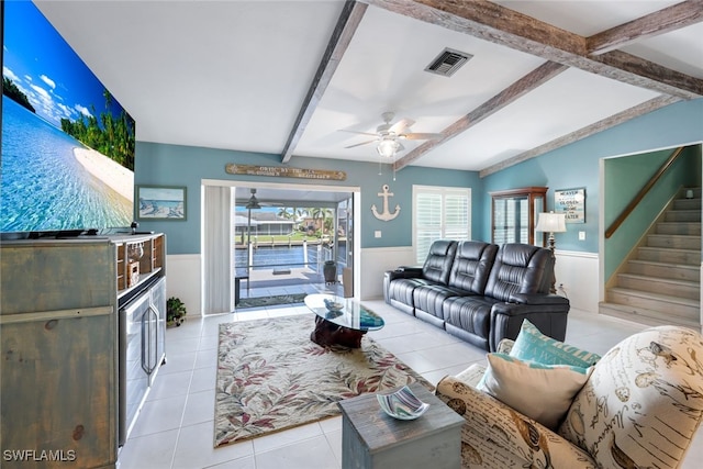 living room with ceiling fan, light tile patterned floors, and vaulted ceiling with beams