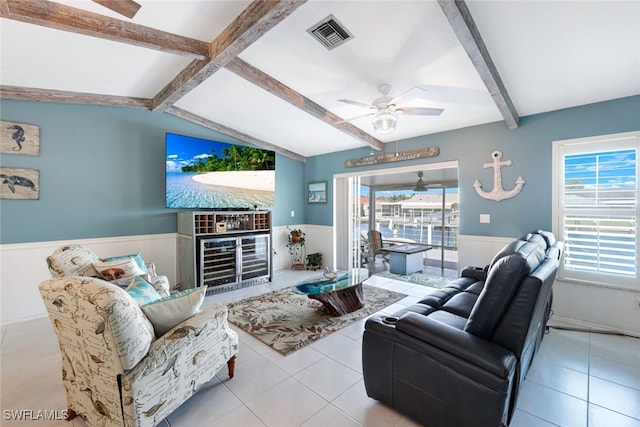 tiled living room featuring ceiling fan and lofted ceiling with beams