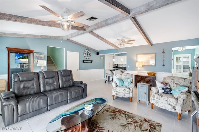 tiled living room featuring ceiling fan and lofted ceiling with beams