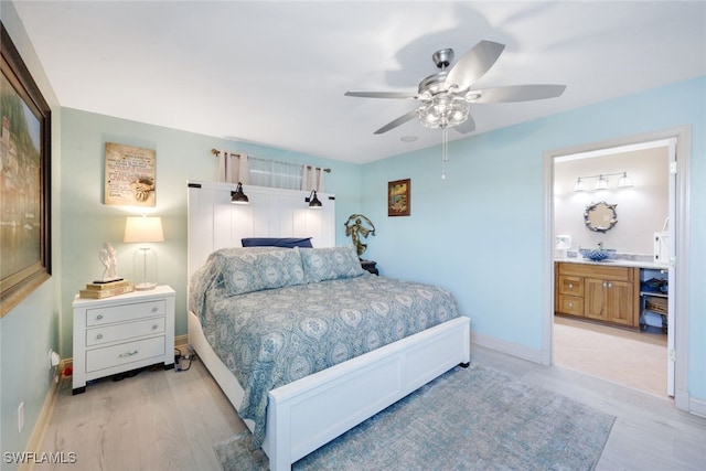 bedroom with light hardwood / wood-style flooring, connected bathroom, and ceiling fan