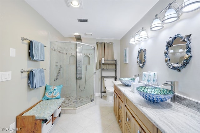 bathroom with an enclosed shower, tile patterned floors, toilet, and vanity