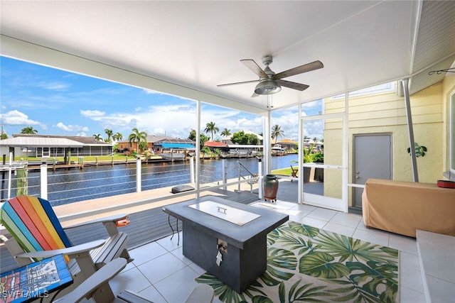 view of patio with a water view and ceiling fan