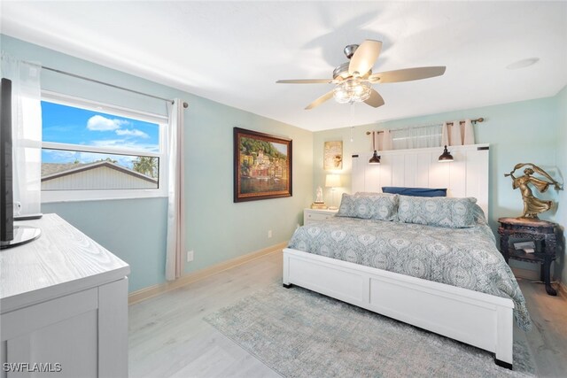 bedroom with light wood-type flooring and ceiling fan