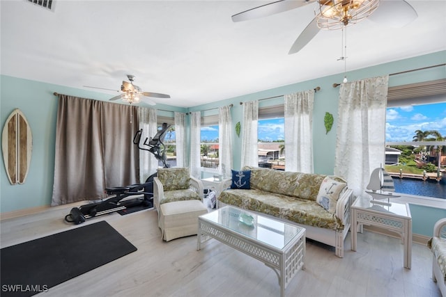 living room with ceiling fan and light hardwood / wood-style floors