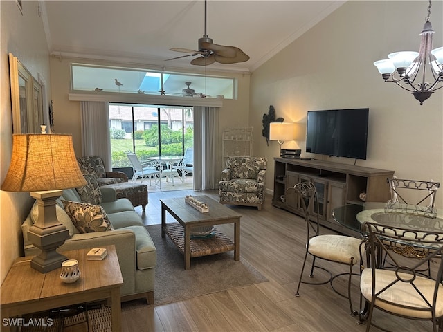 living room featuring ornamental molding, vaulted ceiling, ceiling fan with notable chandelier, and hardwood / wood-style floors