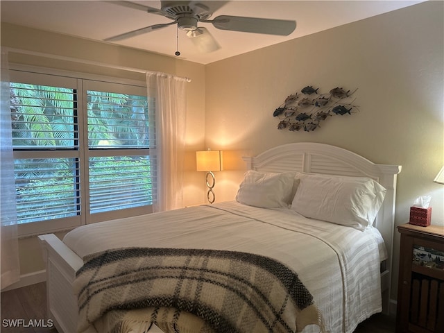 bedroom featuring ceiling fan and dark hardwood / wood-style floors