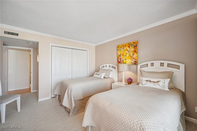 bedroom with ornamental molding, light colored carpet, and a closet