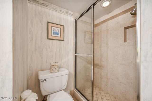 full bathroom with a shower stall and toilet