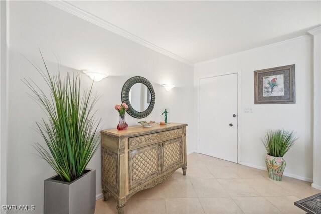 foyer featuring crown molding and light tile patterned flooring